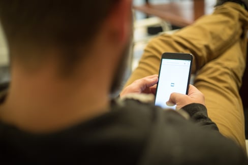 Man on Mobile Phone Participating in Online Fundraiser