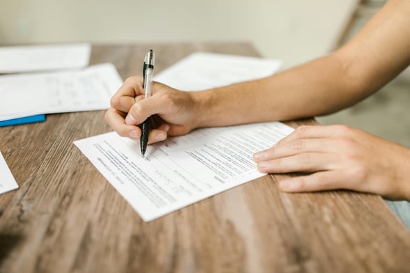 Parent filling out field trip registration forms for their children