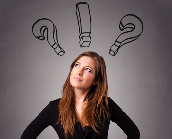 Beautiful young lady thinking with question marks overhead-1-1